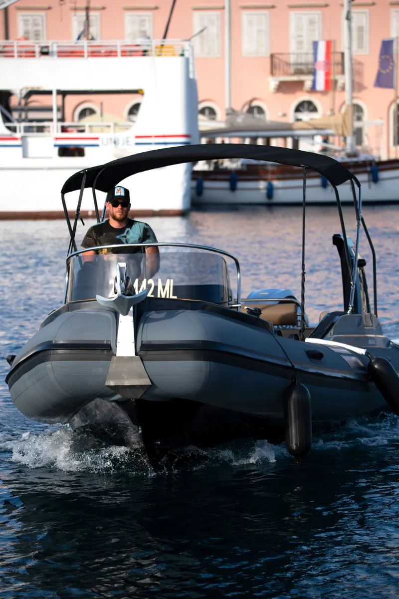 Speed boat navigating the crystal-clear Adriatic Sea near Lošinj.